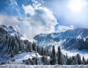 Winter Snowy Mountains valley with fog and sun in Chumbulak, Almaty, Kazakhstan